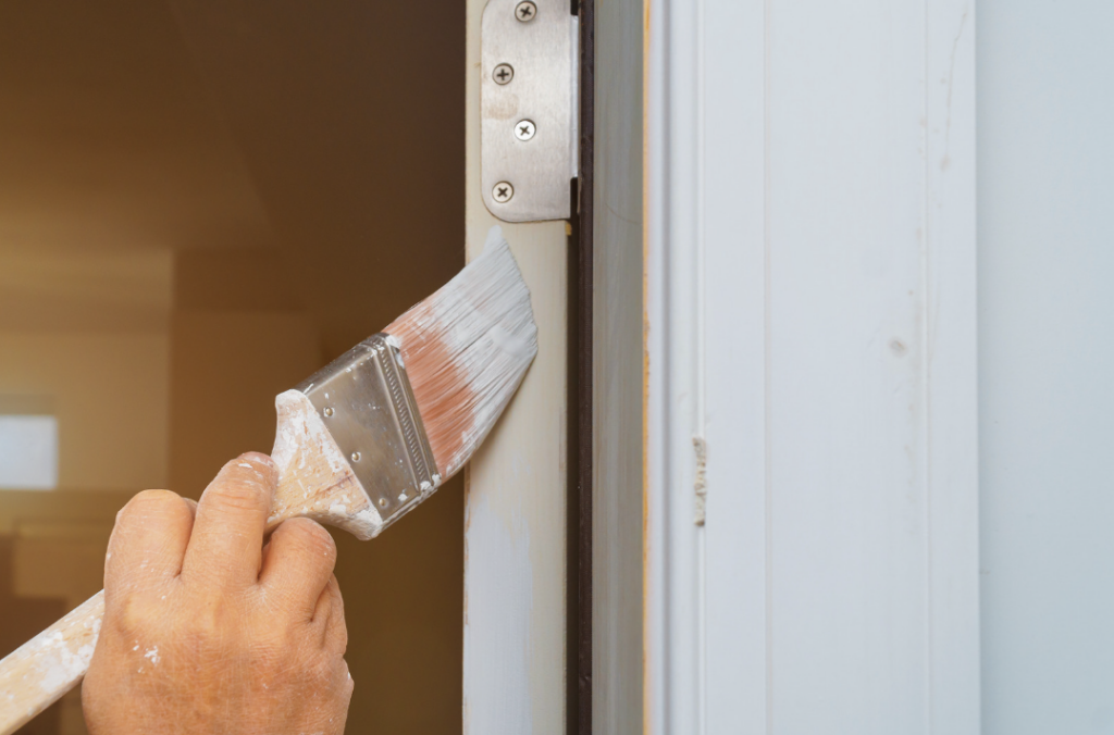 person painting front door white